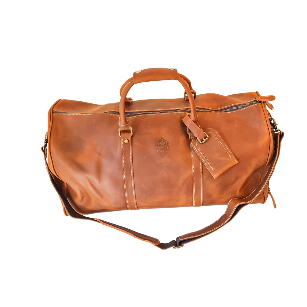 The Hinterland Genuine Leather Duffle Bag - front on - embossed logo - tan leather