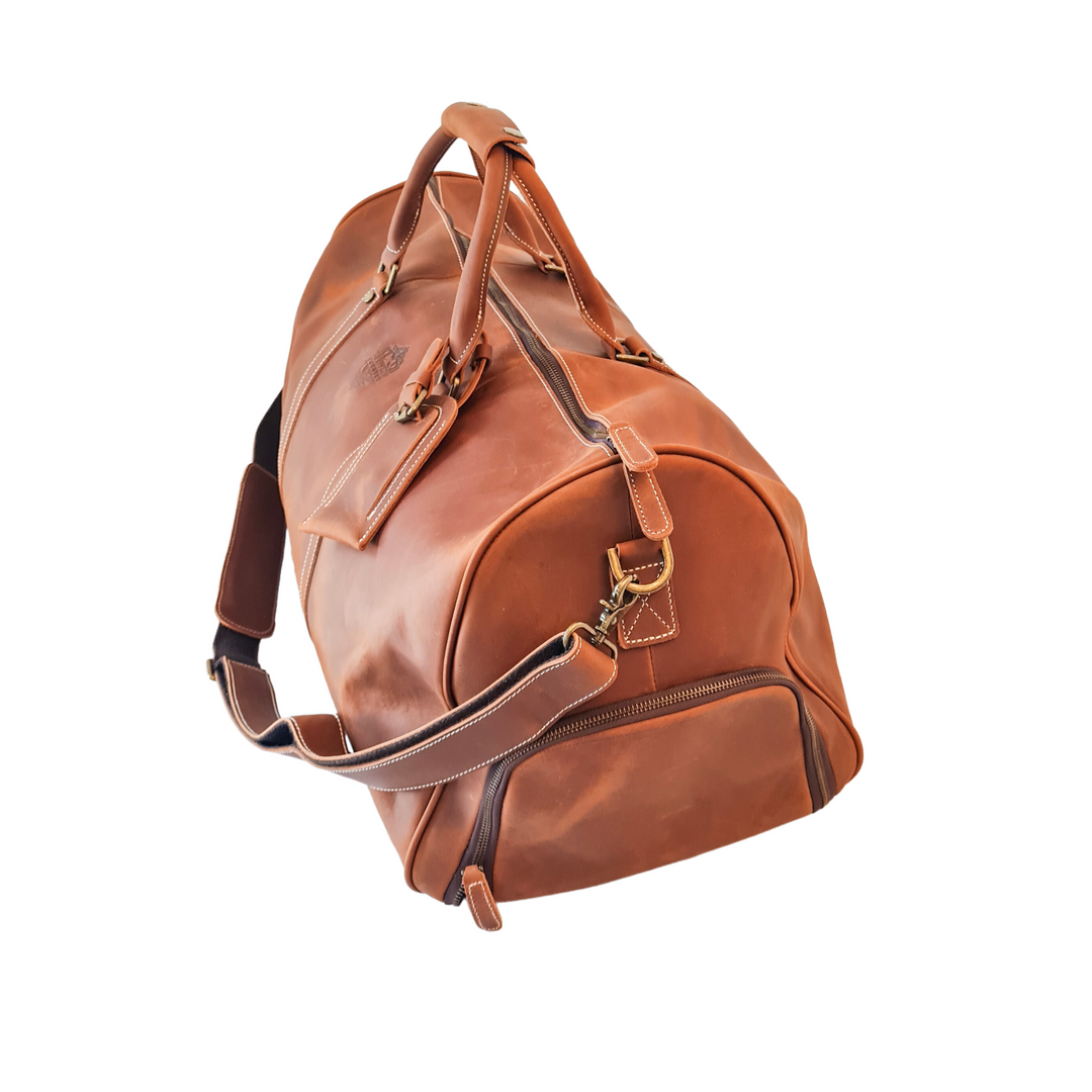 The Hinterland Genuine Leather Duffle Bag - side on - tan leather - showing shoe pocket